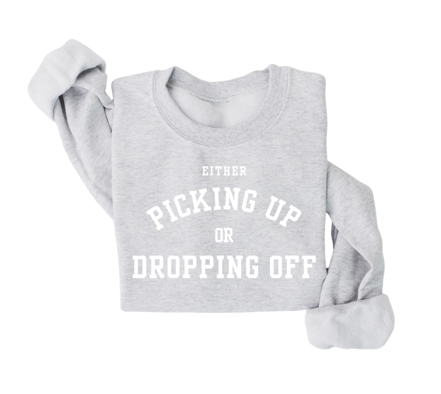 Either picking up or dropping off sweatshirt